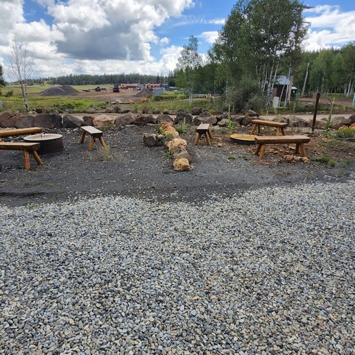 Outdoor fire pit gathering area with wooden benches